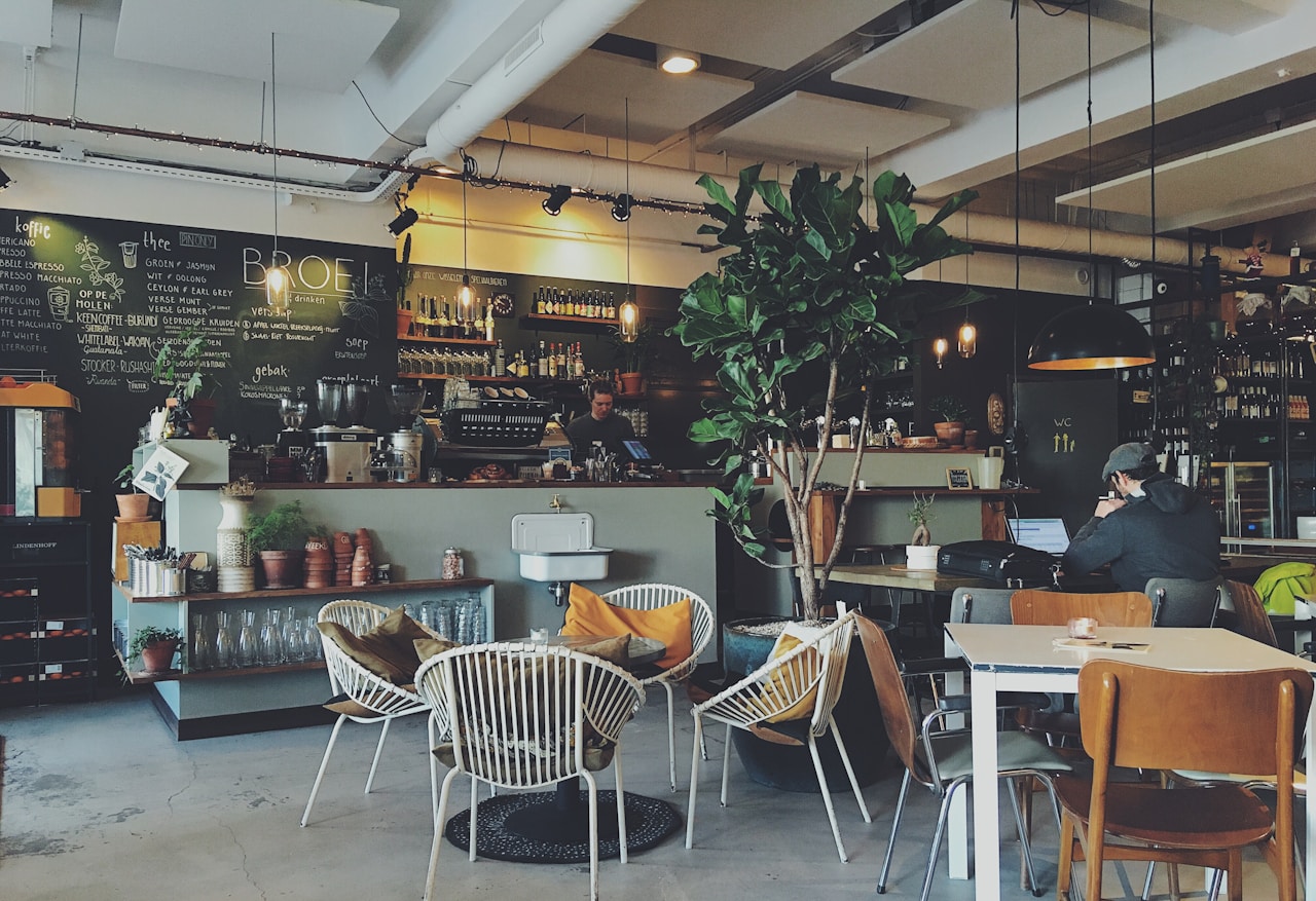 Independent café owner welcoming customers